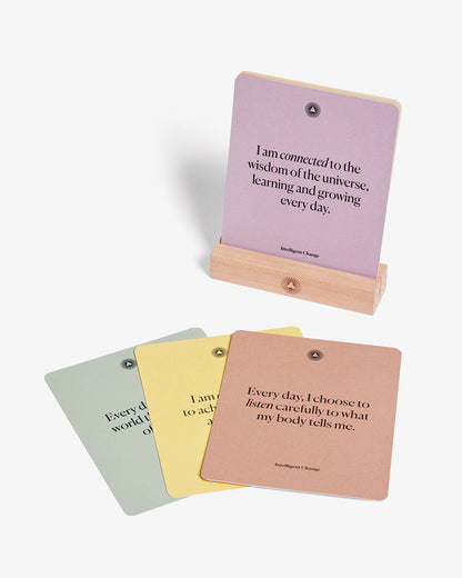 A set of mindful affirmations for chakra balancing by Intelligent Change, featuring calming, positive messages on a serene background.