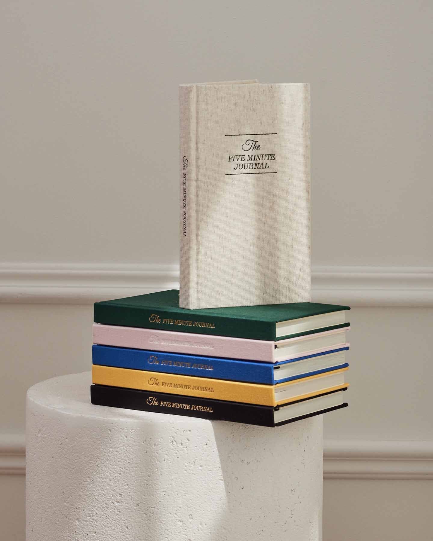 The Five Minute Journal Original Linen by Intelligent Change, a mindfulness journal with a durable linen cover and motivational prompts.