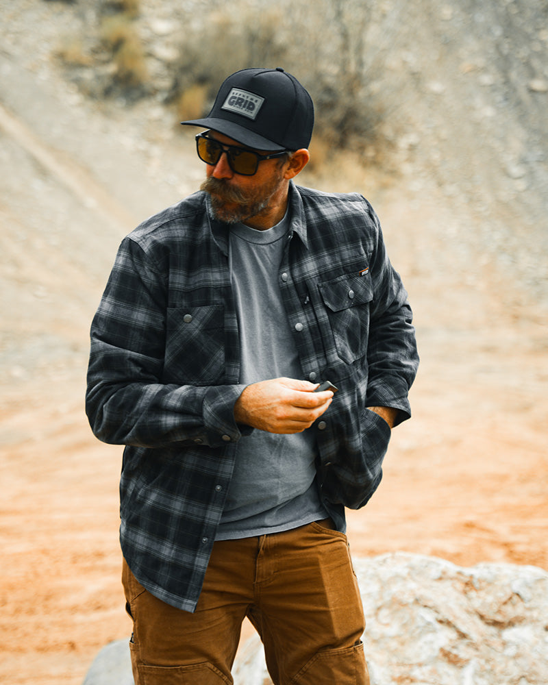 Black Ironside Flannel jacket by Off The Grid Surplus, shown in a close-up image highlighting the fabric and collar details.