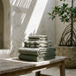 Set of two Italic Umbra Australian cotton bath washcloths in sage and ecru, soft and absorbent for home bath use.