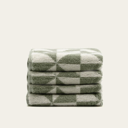 Set of two Italic Umbra Australian Cotton Towels in sage and ecru, soft bath towels for home use, shown folded with textured fabric.