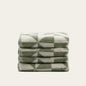 Set of two Italic Umbra Australian Cotton Towels in sage and ecru, soft bath towels for home use, shown folded with textured fabric.