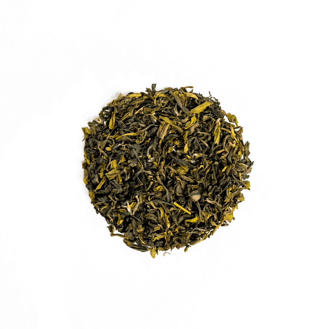 Premium Organic Himalayan Mist Kanchanjangha Verde green tea from Nepal Tea, showcasing fresh green tea leaves in a natural setting.