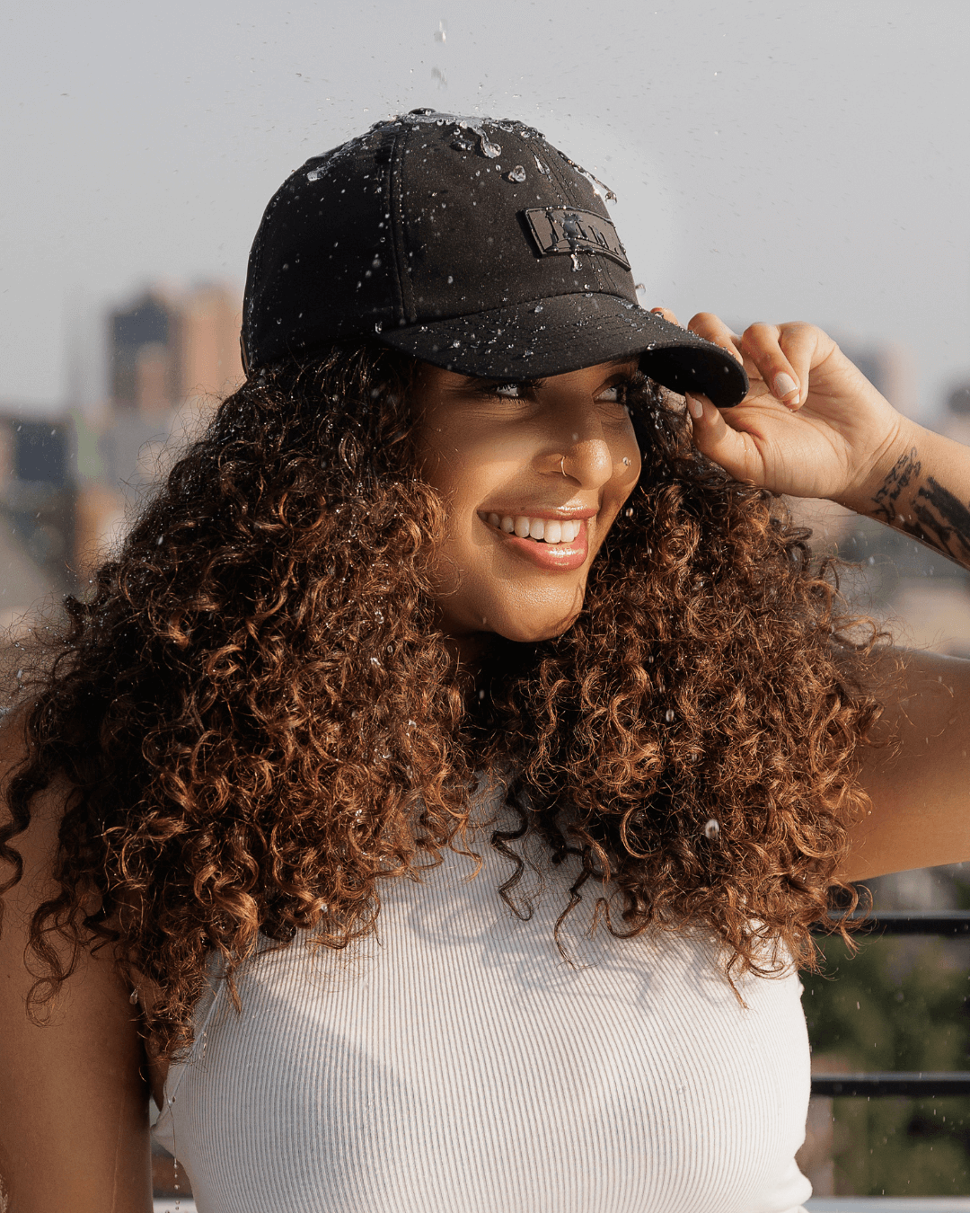 Black waterproof satin-lined dad hat by KINApparel, showing front view with adjustable strap and waterproof fabric.