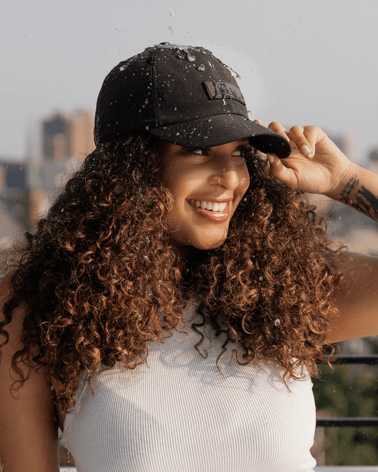 Black waterproof satin-lined dad hat by KINApparel, showing front view with adjustable strap and waterproof fabric.