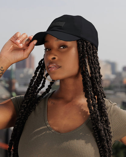 Black waterproof satin-lined dad hat by KINApparel, featuring a classic design and adjustable strap for a comfortable fit.
