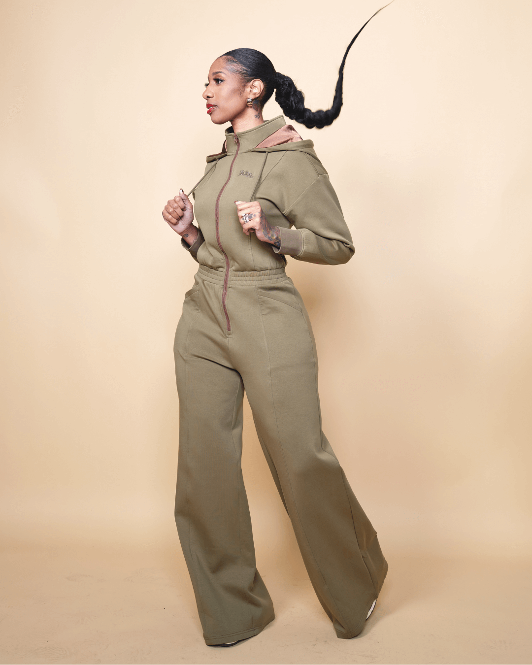 Green satin-lined jumpsuit by KINApparel, shown in XS regular fit with a sleek, smooth fabric and tailored design.