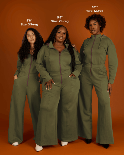 Green satin-lined jumpsuit by KINApparel, featuring a fitted design and long sleeves, styled on a model.