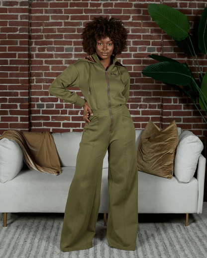 Green satin-lined jumpsuit by KINApparel, featuring a stylish, comfortable design with a smooth, shiny fabric and relaxed fit.