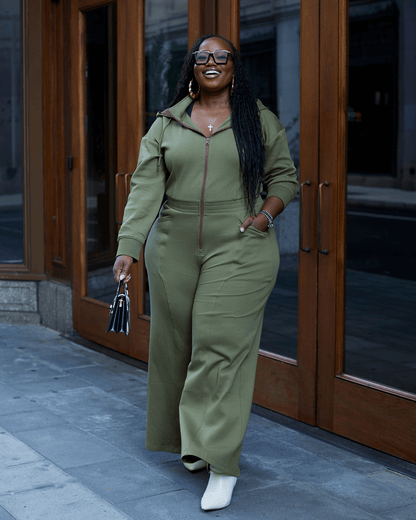 Green satin-lined jumpsuit by KINApparel, featuring a sleek design and comfortable fit, shown in a regular XS size.