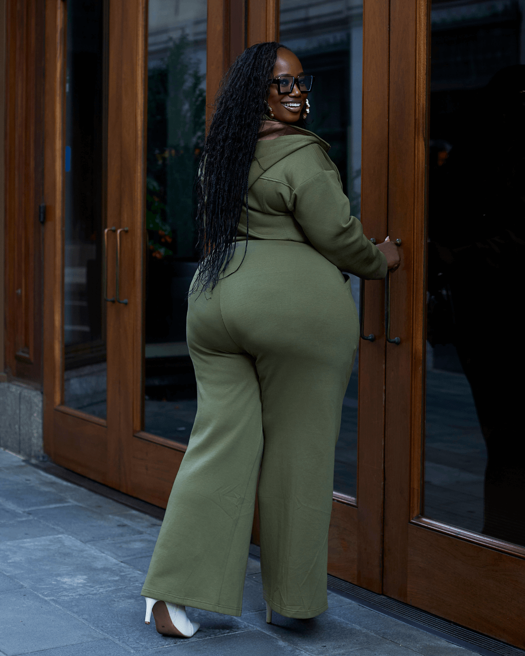 Green satin-lined jumpsuit from KINApparel, shown in size XS with a relaxed fit and smooth, shiny fabric.