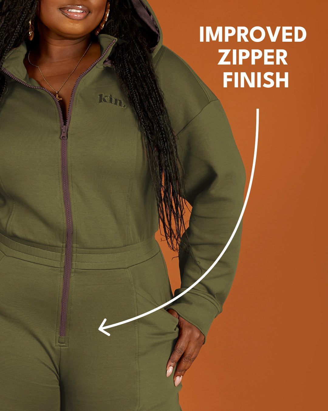 Green satin-lined jumpsuit by KINApparel, showing the fitted design, long sleeves, and smooth satin fabric.