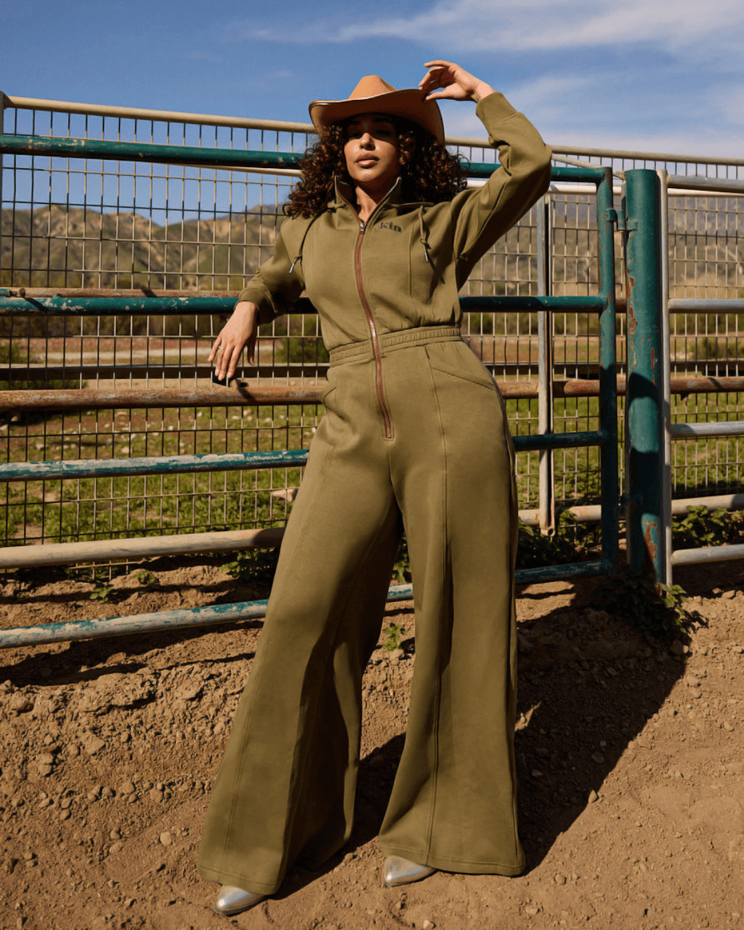 Green satin-lined jumpsuit by KINApparel, shown in XS size with a relaxed fit and smooth satin interior.