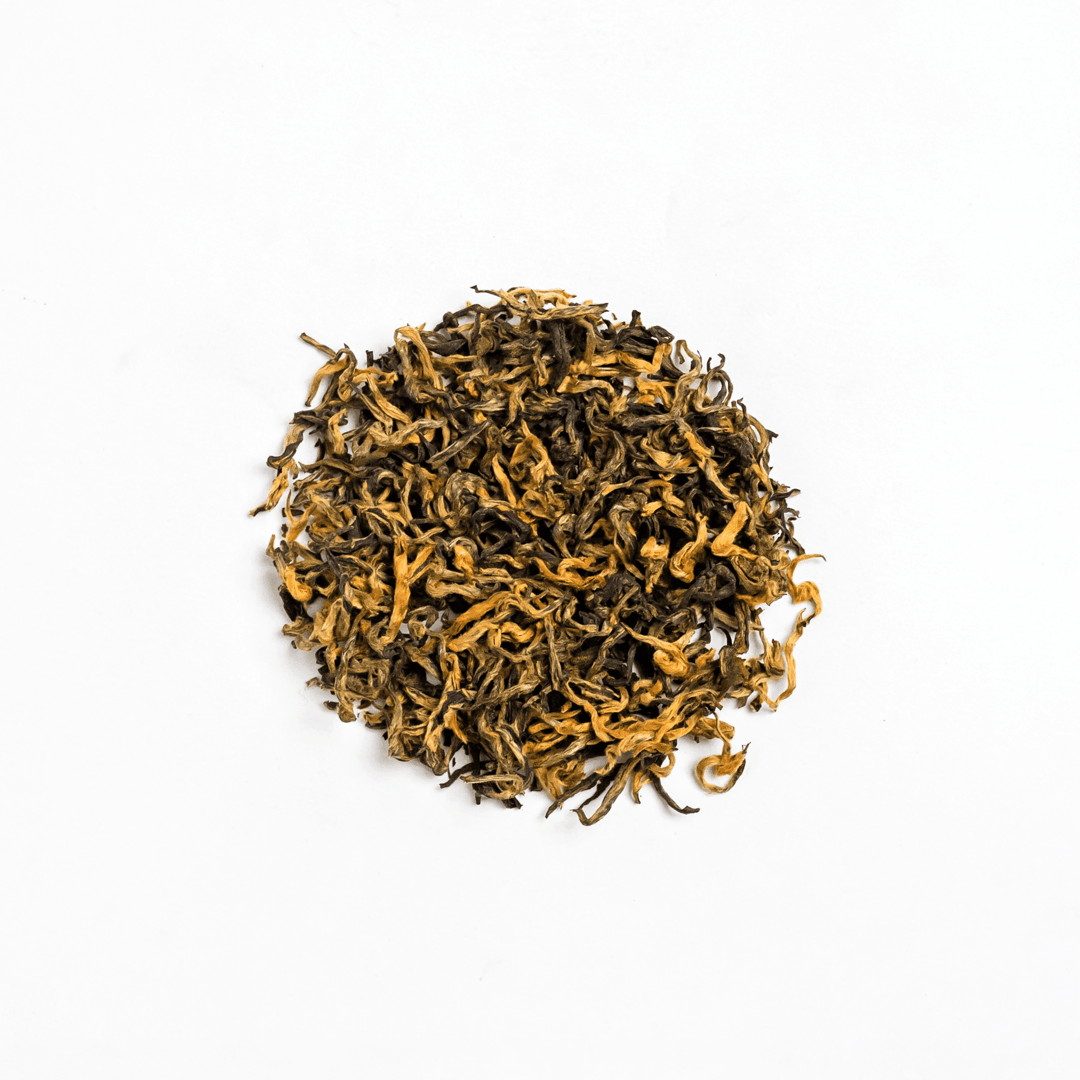 Organic Kumari Gold tea from Nepal Tea, featuring golden-colored tea leaves in a clear glass jar.