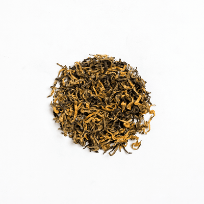 Organic Kumari Gold tea from Nepal Tea, featuring golden-colored tea leaves in a clear glass jar.