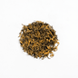 Organic Kumari Gold tea from Nepal Tea, featuring golden-colored tea leaves in a clear glass jar.