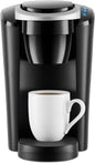 Keurig K-Compact single-serve coffee maker in black by KupofK Coffee, with a compact design and drip tray for brewing coffee.