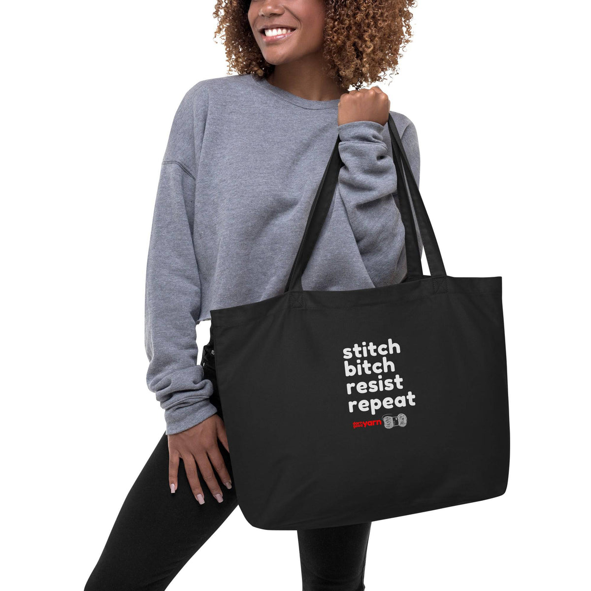 Large black organic tote bag with Stitch Bitch Resist Repeat design by Darn Good Yarn, eco-friendly and spacious for shopping or errands.