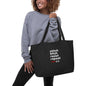Large black organic tote bag with Stitch Bitch Resist Repeat design by Darn Good Yarn, eco-friendly and spacious for shopping or errands.