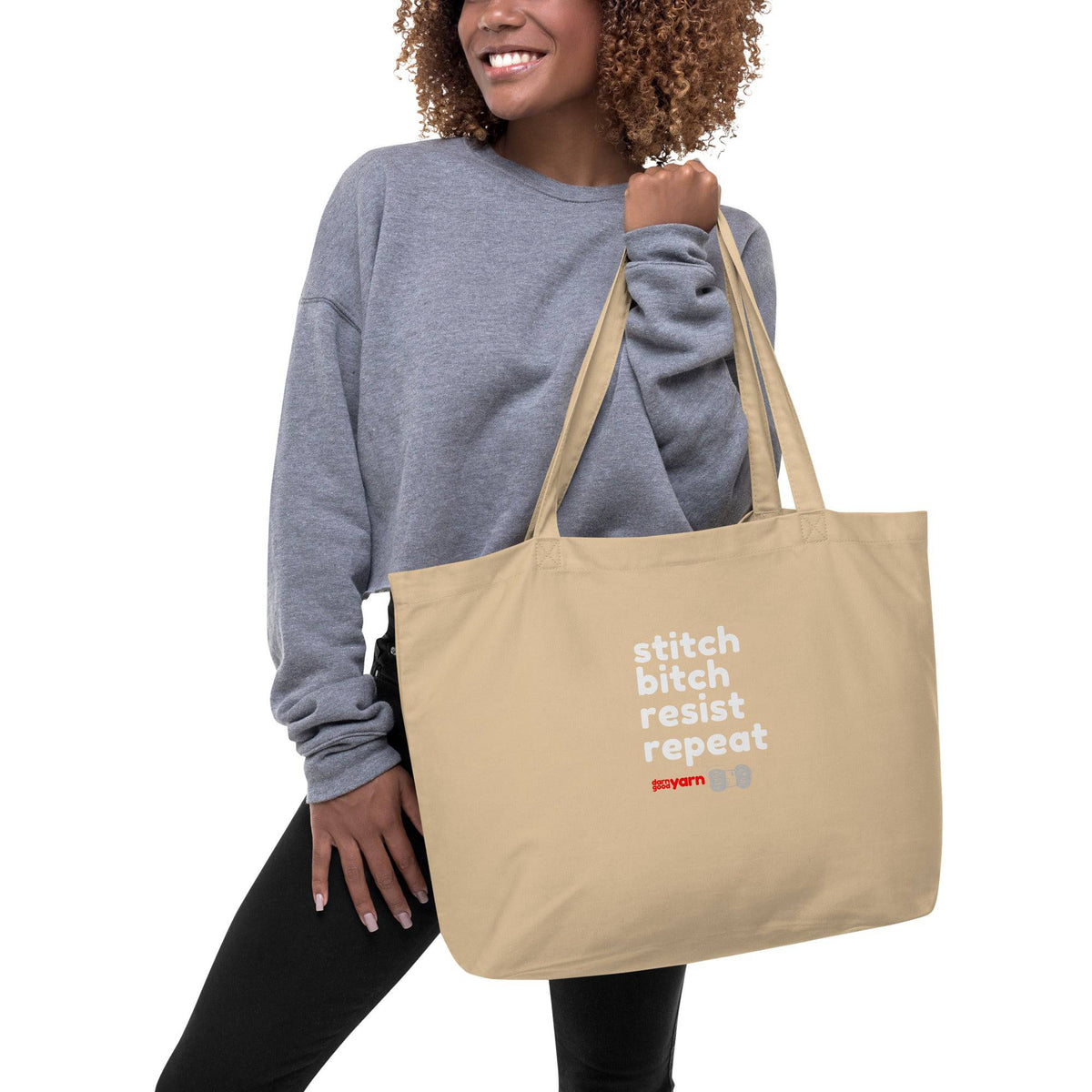 Large organic tote bag featuring Stitch Bitch Resist Repeat design by Darn Good Yarn, with oyster-colored fabric and eco-friendly materials.