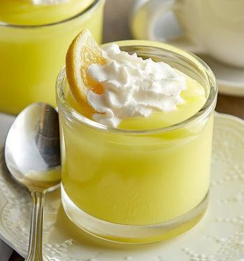 Creamy Lemon Creme Pudding by AmBari Nutrition in a bowl, topped with lemon zest and served as a sweet dessert.