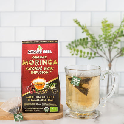 Organic Miracle Tree Moringa Energy Tea with cherry and chamomile, a natural coffee alternative, in a vibrant tea cup.