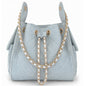 Medium Bayshore Bucket Bag by BEACH HAUS in light wash denim, showing the spacious bag with denim texture and stylish design.