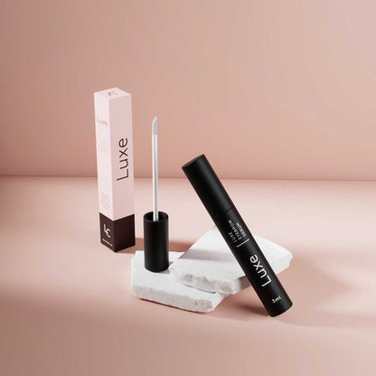 Luxe Cosmetics US Luxe Eyebrow Growth Serum bottle with a sleek design and applicator brush, set against a plain background.