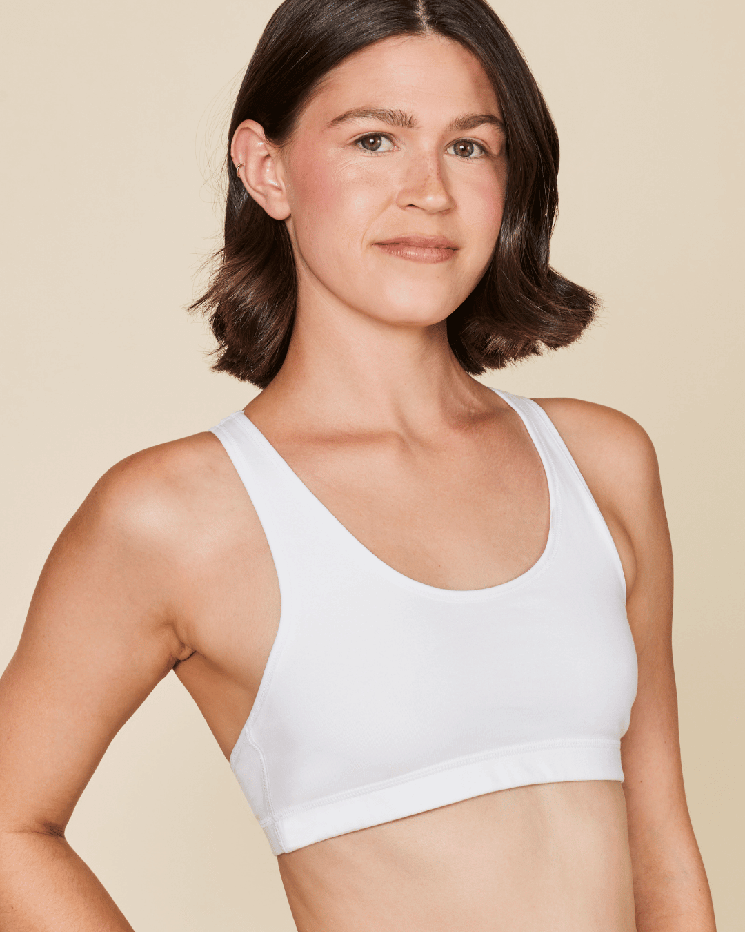 Black Meadow Glide Cotton Racerback Bralette sports bra shown on a small mannequin, highlighting its comfortable racerback design.