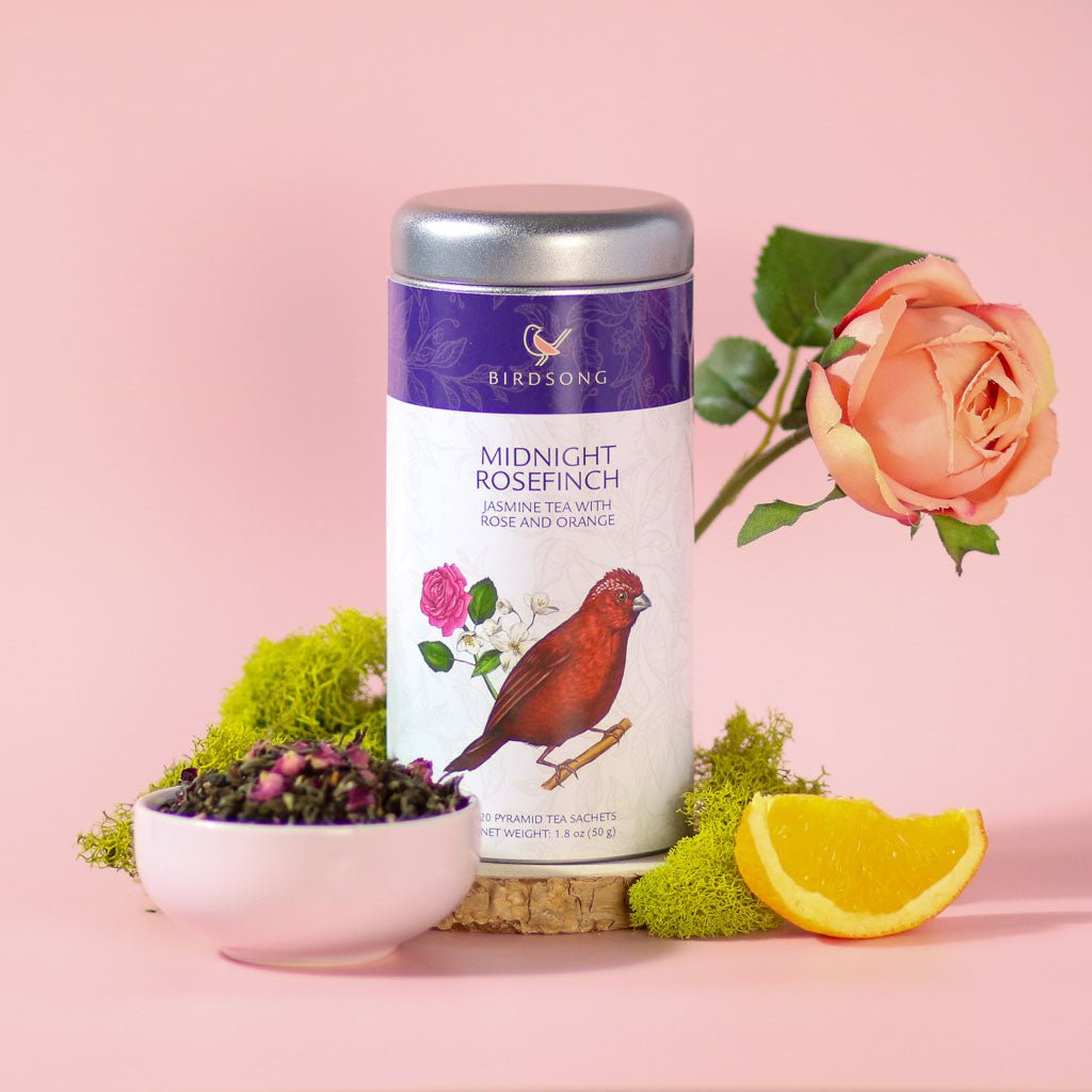 Green jasmine tea called Midnight Rosefinch from Birdsong Tea, featuring fresh orange and floral rosefinch accents.