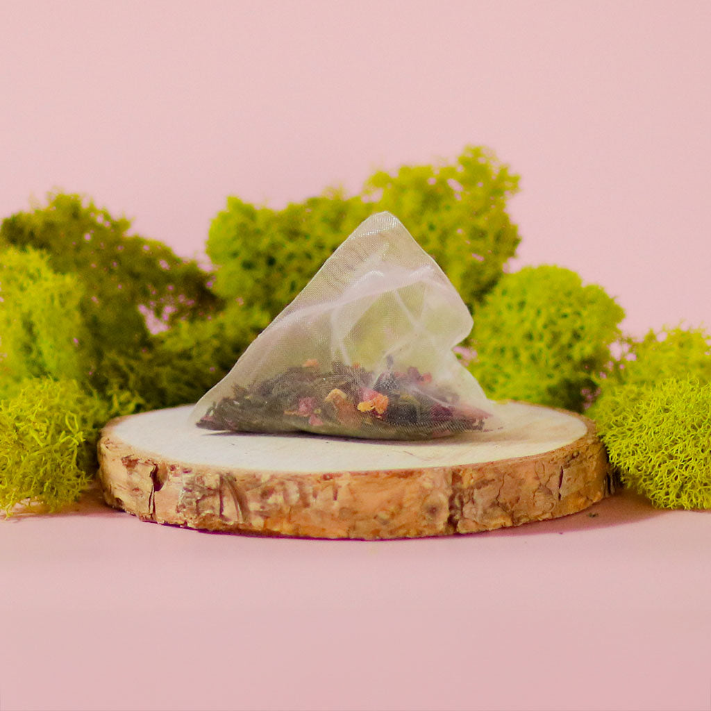 Green tea blend called Midnight Rosefinch by Birdsong Tea with jasmine flowers and orange slices.