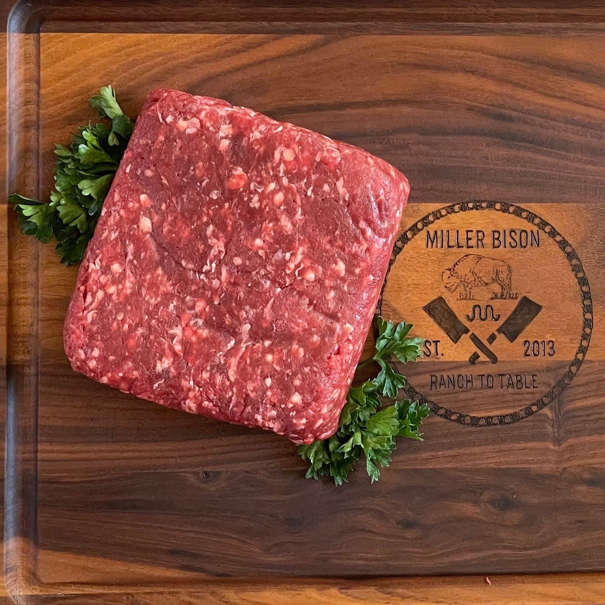 Ground bison meat from Miller Bison LLC, 10 lb package, raw ground bison with a natural red color and ground meat texture.