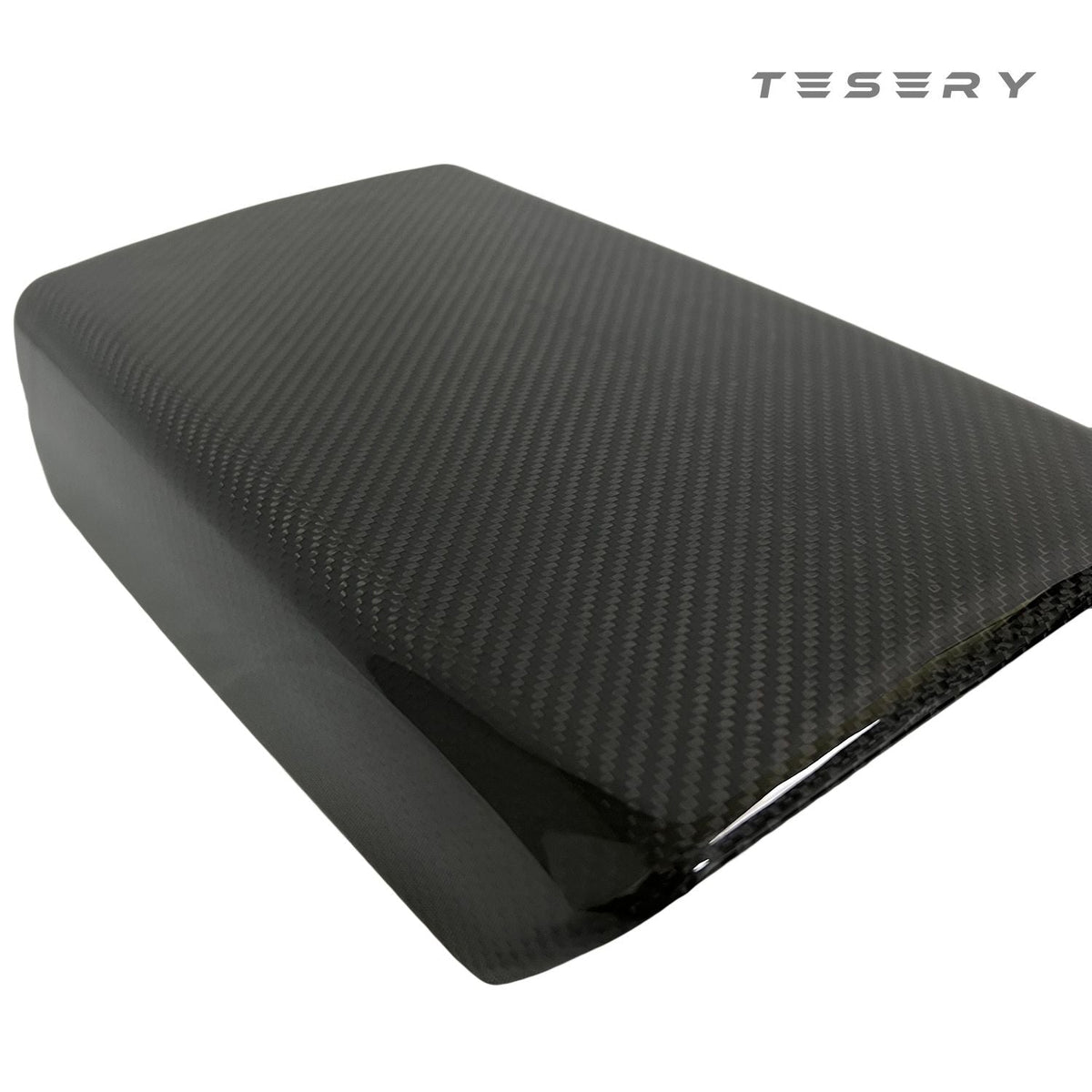 Tesla Model Y armrest cover in dry carbon fiber, interior mod by Tesery, showcasing sleek, textured carbon fiber material.
