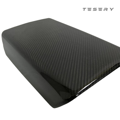 Tesla Model Y armrest cover in dry carbon fiber, interior mod by Tesery, showcasing sleek, textured carbon fiber material.