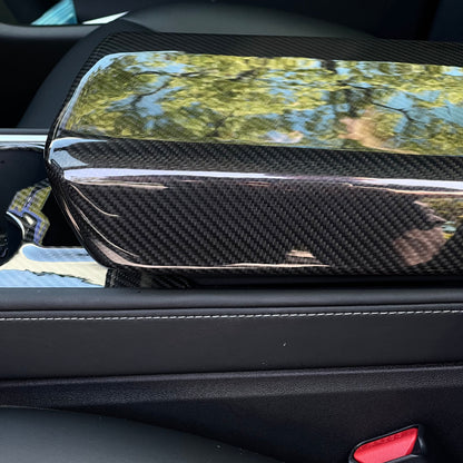 Tesla Model Y armrest cover in dry carbon fiber, custom interior mod by TESERY for a sleek, modern look.