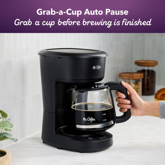 Black Mr. Coffee programmable 12-cup coffee maker with digital display and brewing buttons on a kitchen countertop.