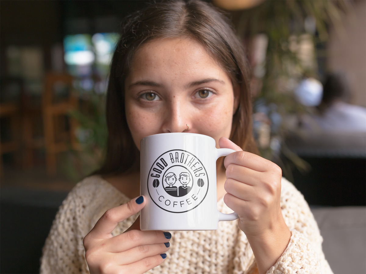 Beautiful girl drinking hot roasted coffee in a mug, showcasing Good Brothers Coffee LLC.'s Roaster's Choice Coffee, 8oz or 12oz.