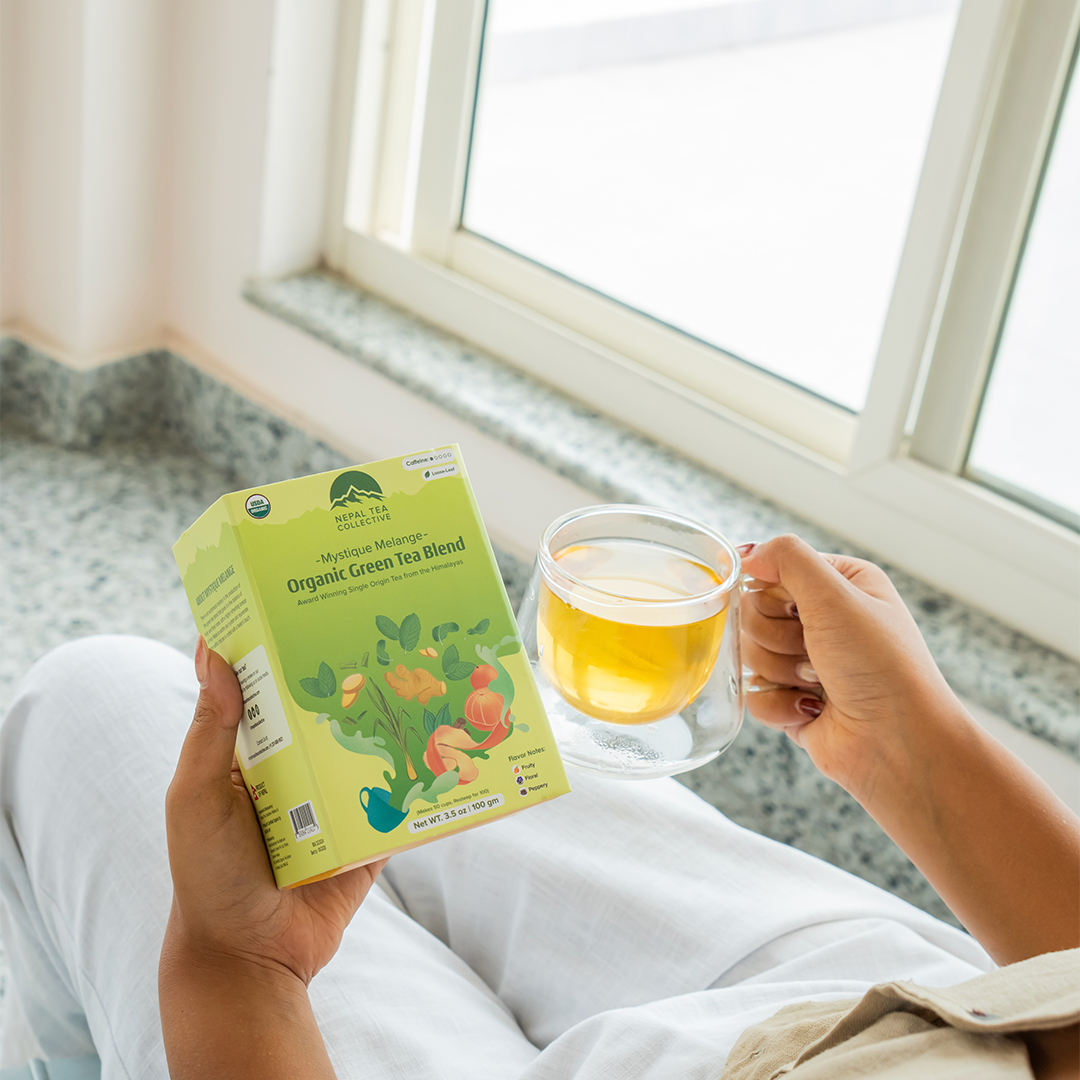 Organic Mystique Mélange tea blend by Nepal Tea, featuring a colorful mix of dried herbs and leaves in a vibrant tea mixture.