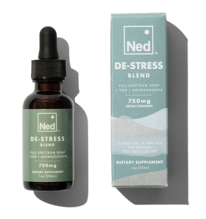 Foria De-Stress Blend oil tincture bottle with dropper, featuring calming herbal ingredients in a natural setting.