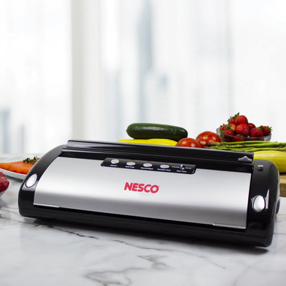 NESCO vacuum sealer machine with built-in roll storage, cutter, accessory port, and two 10-ft sealing rolls for food preservation.