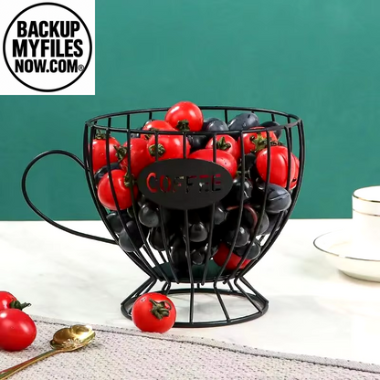 Black mug-shaped coffee pod holder with large capacity for organizing coffee pods and creamer containers.