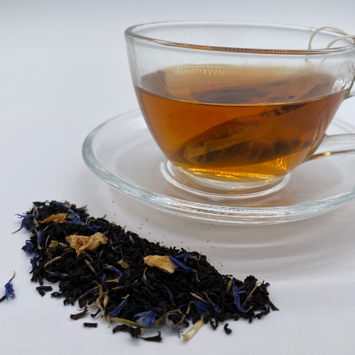 Loose leaf Earl Grey Moonlight black tea in a clear glass jar, showcasing dark tea leaves with citrus and floral notes.