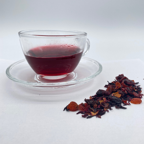 Loose leaf Berry Blast herbal tea from Novel Tea Book Shop, with dried berry pieces and aromatic herbs in a clear container.