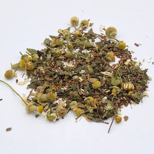 Foxtrot herbal loose leaf tea by Novel Tea Book Shop, showing dried tea leaves in a clear glass jar.