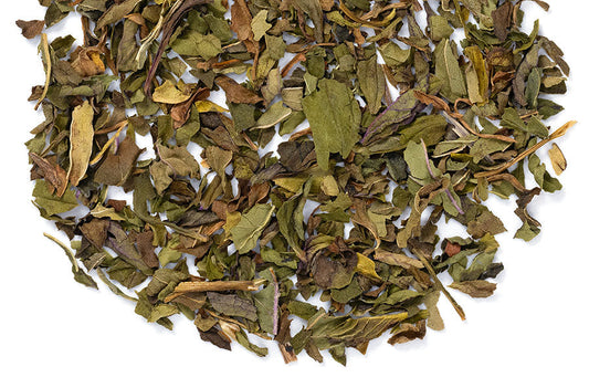 Peppermint loose leaf herbal tea in a clear jar, fresh green leaves, ideal for tea lovers, from Novel Tea Book Shop.