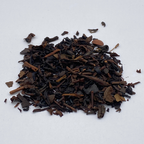 Vanilla Oolong loose leaf tea by Novel Tea Book Shop, showcasing golden-brown tea leaves with vanilla aroma in a clear container.
