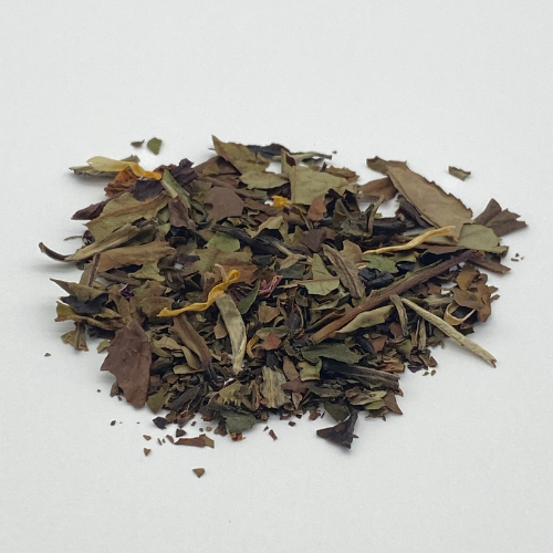 White Buddha's Dream loose leaf tea from Novel Tea Book Shop, showcasing fresh, light-colored white tea leaves in a clear container.