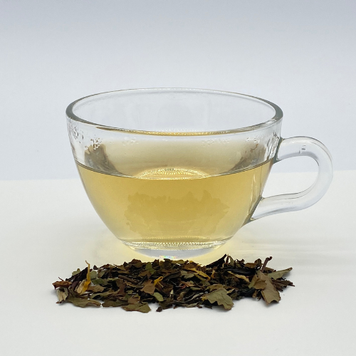 White Buddha's Dream Loose Leaf Tea from Novel Tea Book Shop, featuring delicate white tea leaves in a glass jar.