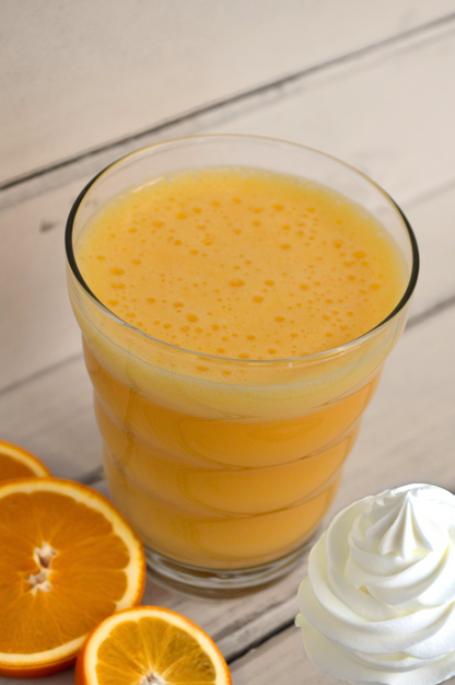 Orange Creamsicle Shake by AmBari Nutrition featuring a creamy orange and vanilla protein powder in a glass.