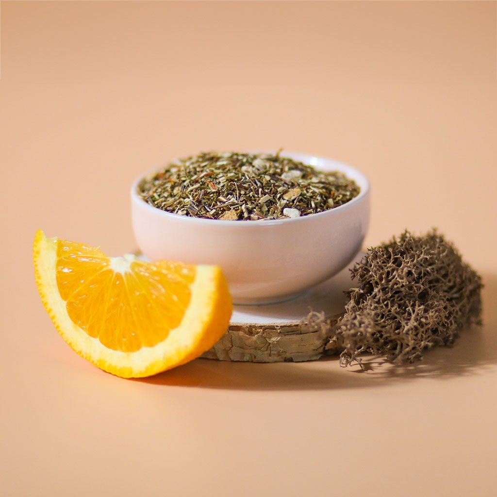 Orange Sugarbird herbal tea by Birdsong Tea with vibrant orange and green Rooibos tea leaves in a close-up view